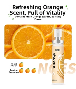 Detail of 20ml orange breath spray with fresh orange fruit slices on vibrant background