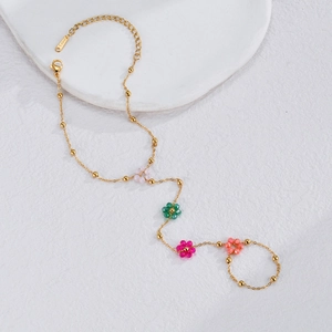Detail showing colorful beaded flowers on an 18K gold-plated stainless steel chain necklace