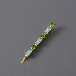 Minimalist gold hair clip with alternating round and rectangular green rhinestones