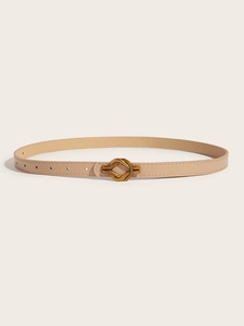 Detail of slim beige leather belt with a vintage gold twist buckle for a classic look