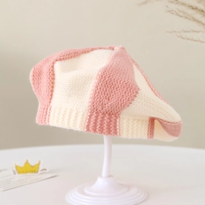 Detail of pink and beige striped knit baby beret with soft texture and ribbed trim
