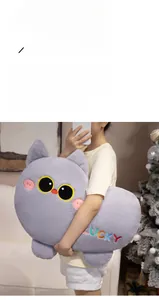 Close-up of a large grey plush cat pillow with Lucky embroidery in a home setting