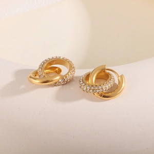 Close-up of 18K gold stainless steel earrings with interlocking rings and pave-set zircons