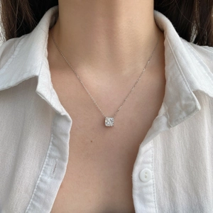 Detail of elegant S925 silver necklace with sparkling square zircon on a female model