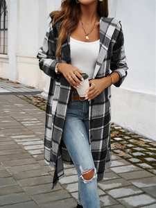 Outdoor street style shot of a long black and white plaid hooded coat for women