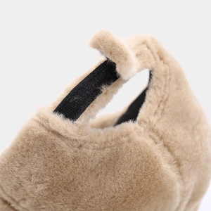 Detail of adjustable velcro closure on soft plush winter baseball cap in beige