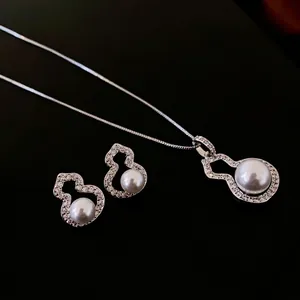 Elegant silver necklace and earrings set featuring zircon gourd shapes and white pearls