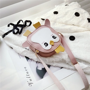 Detail of pink cartoon owl shoulder bag on white polka dot fabric background