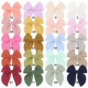 Flat lay of 20 colors cotton bow hair clips in a 5x4 grid display with numeric codes