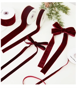Detail of burgundy velvet ribbons in various widths with decorative bows for Christmas