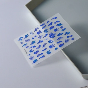 Macro detail of 5D embossed Klein blue floral nail art stickers with metallic texture
