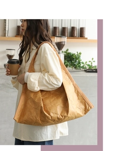 Brown large capacity shoulder tote bag with vintage crinkled paper texture shown in lifestyle