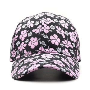 Detail view of black hibiscus print baseball cap with pink flower patterns and stitching