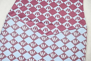 Detailed close-up of geometric diamond texture and stitching on colorful bodycon dress