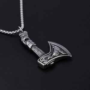 Macro shot of Viking double-axe pendant with wolf relief and vintage steel texture