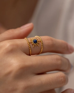 Detail of bohemian gold starburst ring with blue lapis stone inlay for women