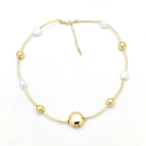 Detail of gold bead necklace with pearls featuring an adjustable lobster clasp closure
