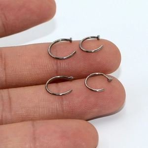 G23 titanium C-shaped non-piercing nose rings in silver finish on fingers
