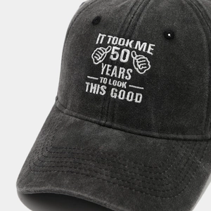 Close-up of vintage washed cotton baseball cap featuring white embroidery and texture