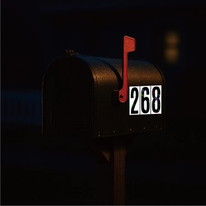Reflective 4-inch vinyl mailbox numbers 268 on black mailbox in night setting