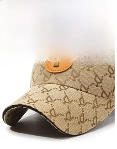 Detail of light brown jacquard baseball cap with Y-pattern and metal logo patch