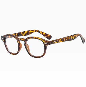 Detail view of tortoiseshell round eyeglass frames with classic rivet accents