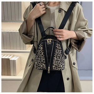 Detail of leopard print拼接 small backpack with dual zippers shown on a model