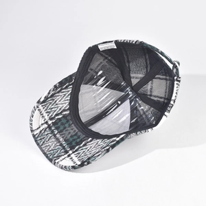 Detail of checkered baseball cap interior with 100% polyester label and black sweatband