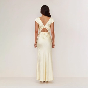 Detail of elegant backless satin dress showing deep V-back and knotted cutout design