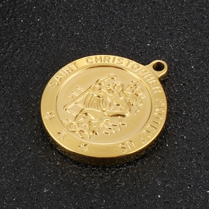 Macro shot of gold Saint Christopher medal pendant with detailed religious engraving