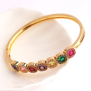 Detailed view of gold plated bracelet featuring square rainbow zircons and polished finish
