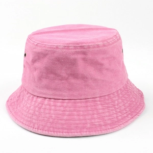 Detail of pink washed cotton bucket hat showing metal eyelets and fabric texture