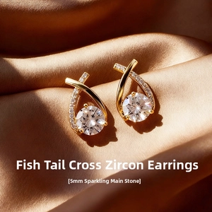 Detailed close-up of fishtail crossover stud earrings with 5mm sparkling zircon stones