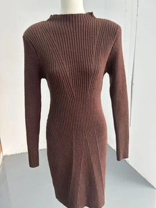 Detailed close-up of dark brown long sleeve knitted dress with ribbed texture and slim fit