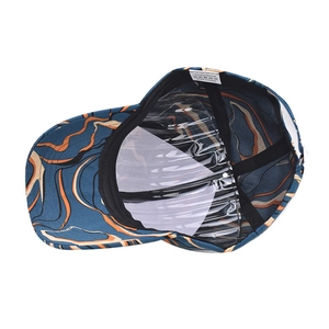 Detail view of tie-dye baseball cap interior with sweatband and 100% polyester tag