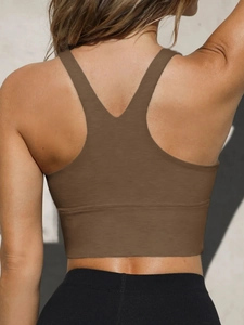Macro shot of brown racerback sports bra showing elastic fabric and muscle fit on the back