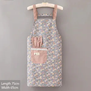 Detail of floral apron with pink polka dot pockets, lace trim and rabbit ear accents