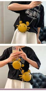 Detailed view of a yellow crab shaped PU leather crossbody bag with golden chain strap