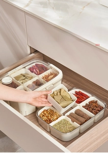 Detail view of transparent seasoning box with divided compartments for kitchen spice storage
