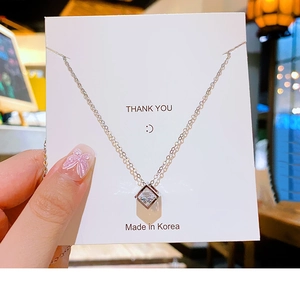 Detail of cubic zircon square pendant on silver titanium steel necklace with fine chain
