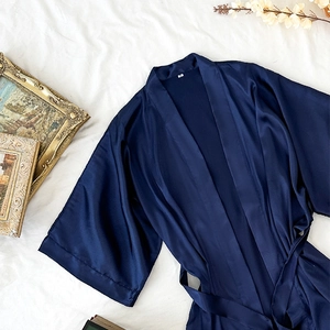 Navy blue satin robe for women with silky texture and waist tie on white background