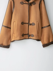 Detailed close-up of brown suede jacket featuring horn buttons and warm faux fur lining