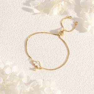 Detail of 18K gold plated adjustable slider bracelet featuring a white cloud pendant