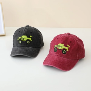 Detailed embroidery of a green monster truck on washed cotton baseball caps for boys