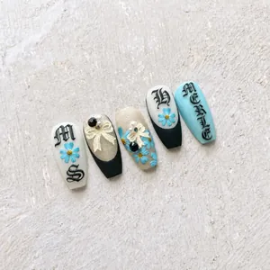 Macro view of 5D embossed nail stickers with vintage blue flowers and 3D bows