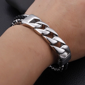 Men's multilayer stainless steel chain and black braided nylon rope bracelet on wrist