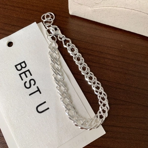 Macro shot of S925 sterling silver curb chain bracelet with lobster clasp and hallmark