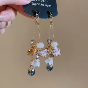 Elegant silver needle drop earrings with geometric crystals and white flower charms