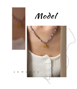 Macro view of Bohemian beaded necklace with blue natural stones and embossed gold pendant