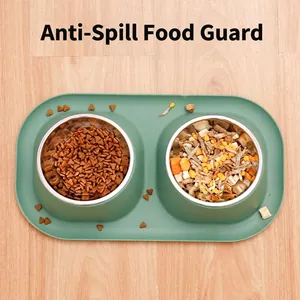 Double stainless steel pet bowls with a green non-slip tray and spill-proof guard